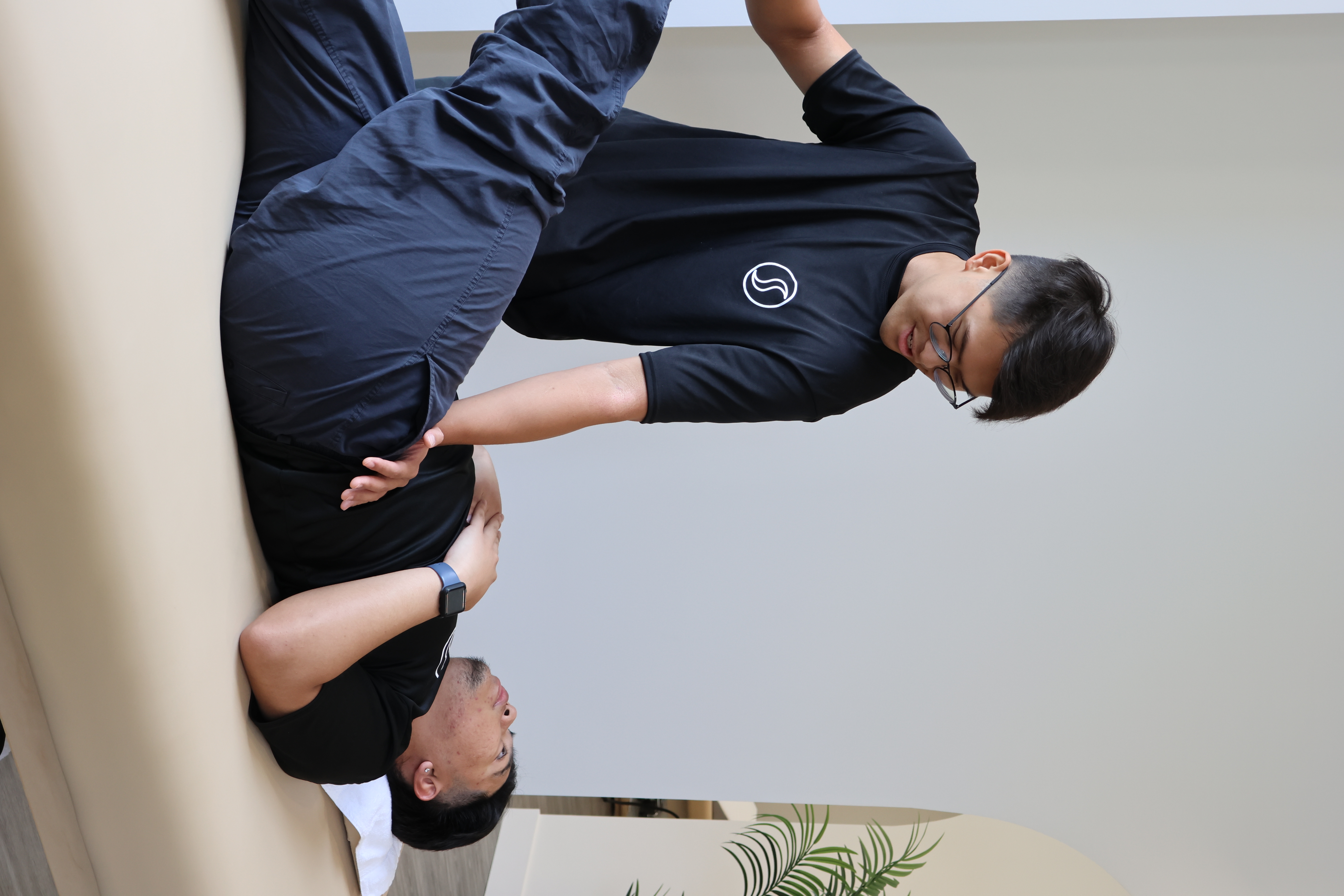 A StretchWell practitioner guiding a client through an assisted stretch